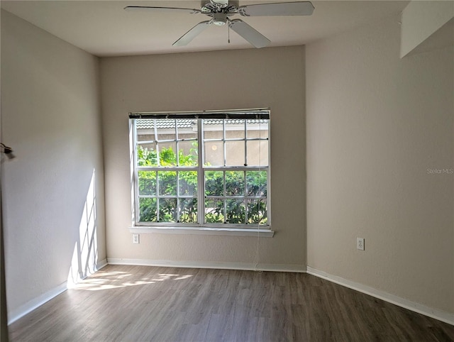 empty room with ceiling fan, baseboards, and wood finished floors