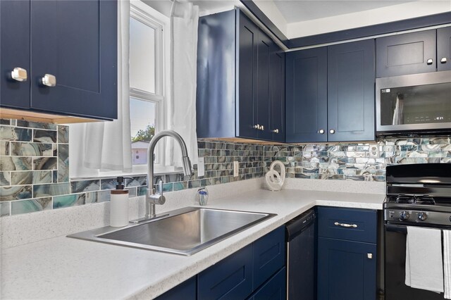 kitchen with blue cabinetry, stainless steel microwave, black gas stove, a sink, and dishwashing machine