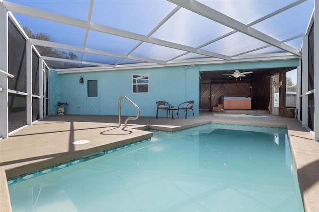 outdoor pool featuring a lanai, a hot tub, ceiling fan, and a patio