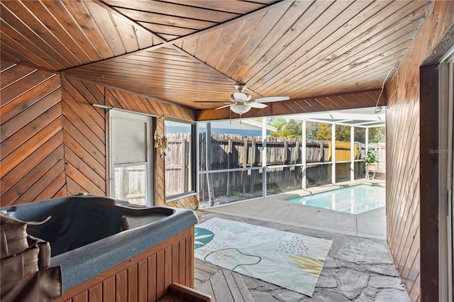 sunroom with wooden ceiling, a pool, and a hot tub