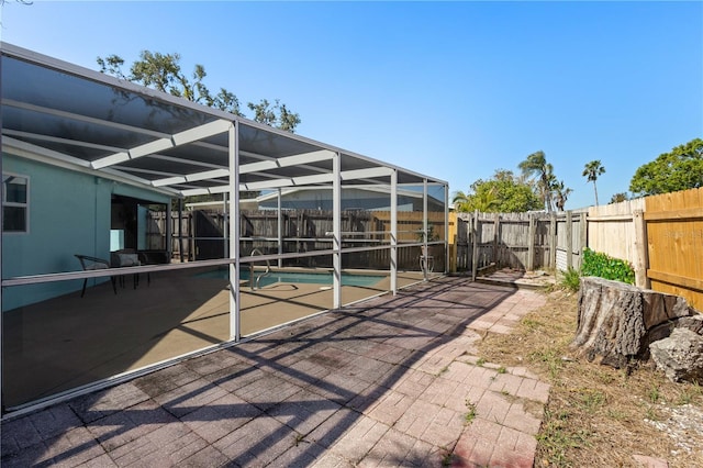 view of car parking with a fenced backyard and a fenced in pool