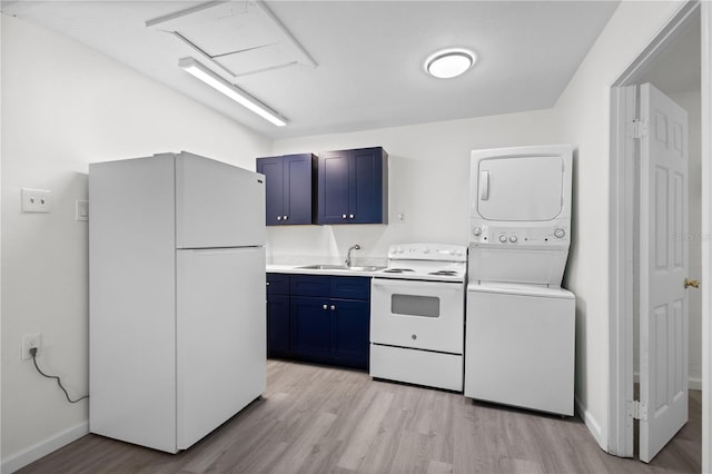 kitchen with white appliances, blue cabinets, light countertops, stacked washing maching and dryer, and a sink