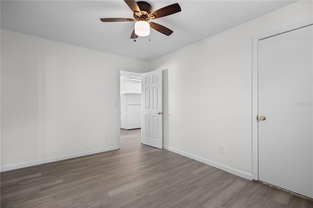 unfurnished bedroom featuring ceiling fan, baseboards, and wood finished floors