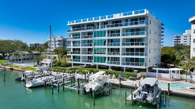 dock area with boat lift and a water view