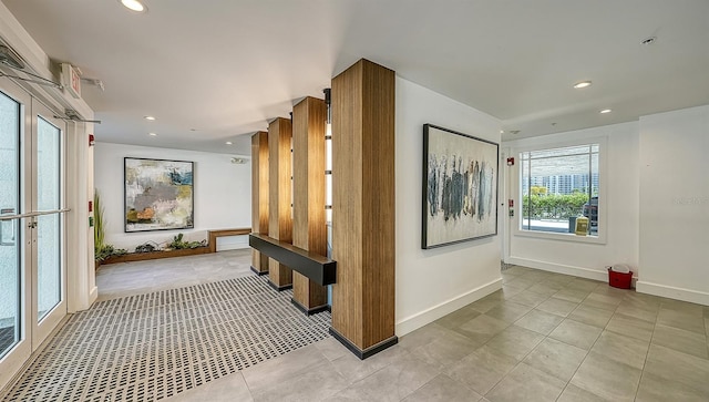 corridor with recessed lighting, baseboards, and light tile patterned floors