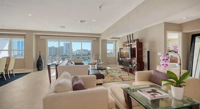 living area with recessed lighting, visible vents, and baseboards