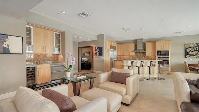 living area featuring visible vents, baseboards, beverage cooler, light tile patterned floors, and recessed lighting