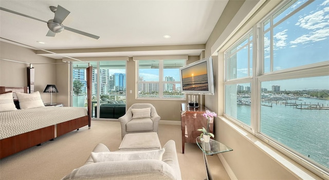 bedroom featuring a ceiling fan, access to exterior, light colored carpet, and baseboards