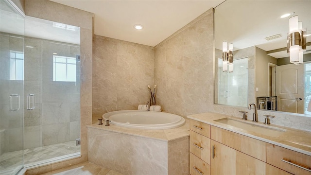 full bath with visible vents, a garden tub, a stall shower, and vanity