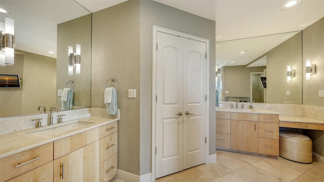 full bathroom with tile patterned flooring, recessed lighting, two vanities, and a sink