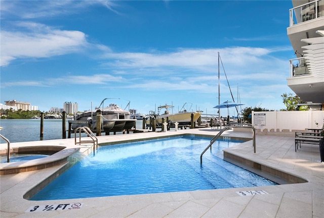 pool with a water view, a community hot tub, a boat dock, a patio, and boat lift