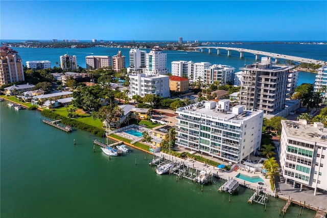 birds eye view of property with a view of city and a water view