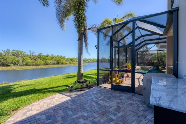 view of patio / terrace featuring a water view, glass enclosure, and a pool with connected hot tub