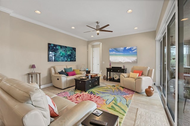 living area with a ceiling fan, arched walkways, crown molding, and recessed lighting