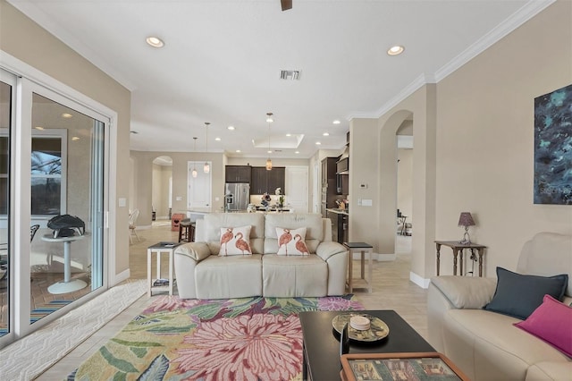 living room featuring arched walkways, recessed lighting, visible vents, and crown molding