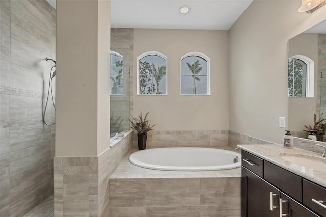 full bath featuring a tile shower, vanity, and a bath