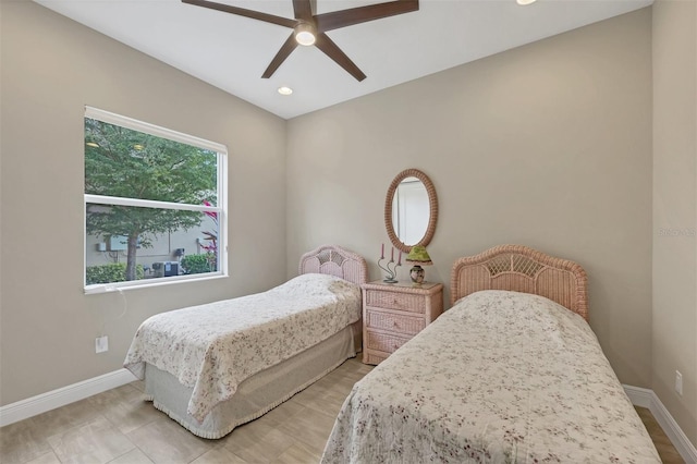 bedroom with ceiling fan and baseboards