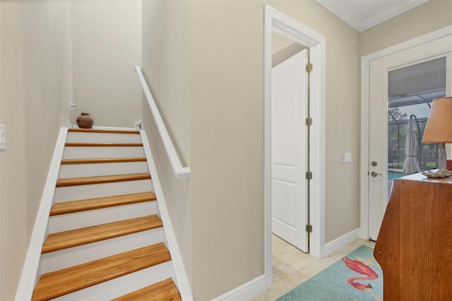 staircase featuring tile patterned flooring and baseboards