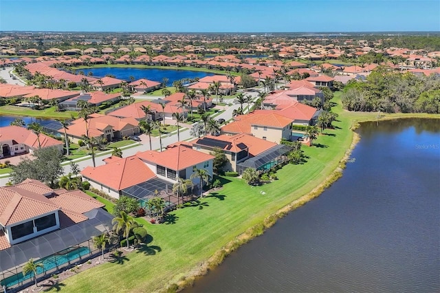 birds eye view of property featuring a water view and a residential view