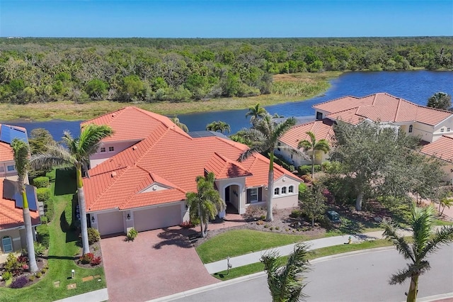 drone / aerial view featuring a water view and a forest view