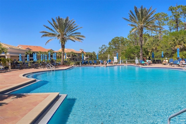 community pool featuring a patio area and fence