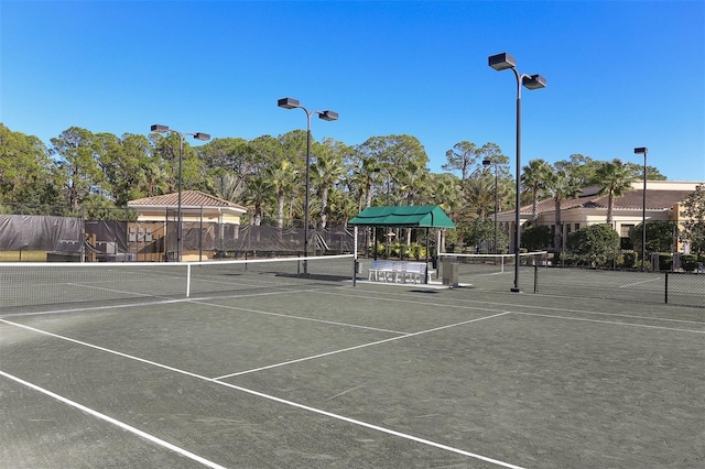 view of tennis court with fence