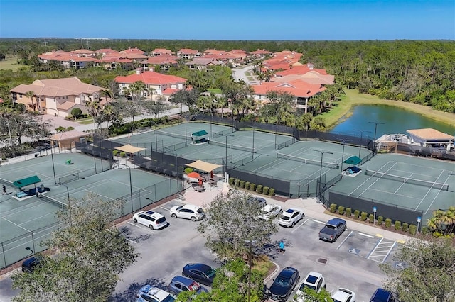 drone / aerial view with a water view and a view of trees