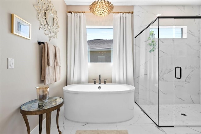 bathroom with marble finish floor, a freestanding tub, and a marble finish shower