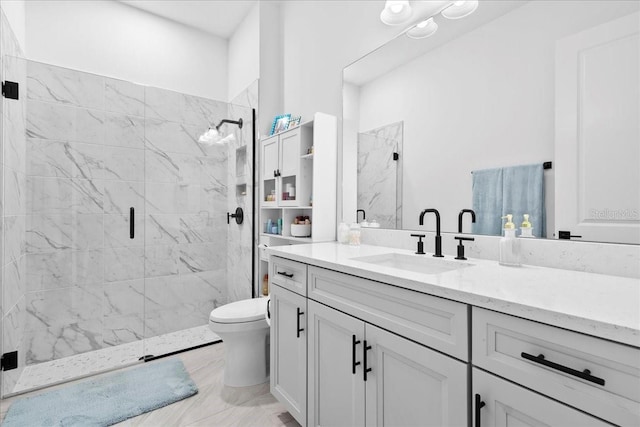 bathroom with toilet, marble finish floor, a marble finish shower, and vanity