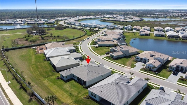 drone / aerial view featuring a residential view and a water view