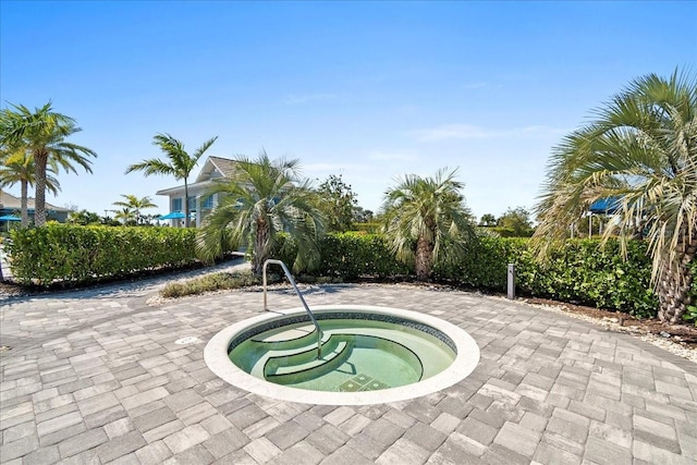 view of swimming pool with a hot tub