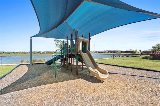 community play area with a lawn and fence