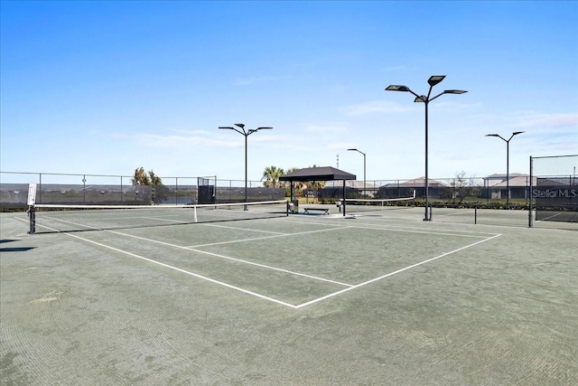 view of sport court featuring fence