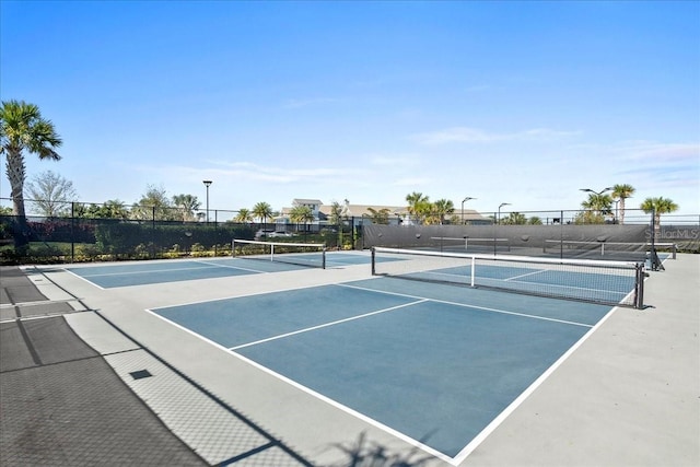 view of sport court featuring fence