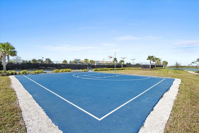 view of sport court with community basketball court, fence, and a yard