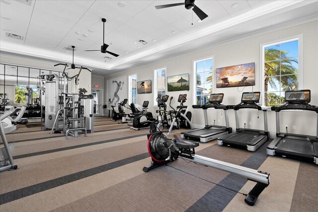 workout area featuring plenty of natural light, visible vents, and a ceiling fan