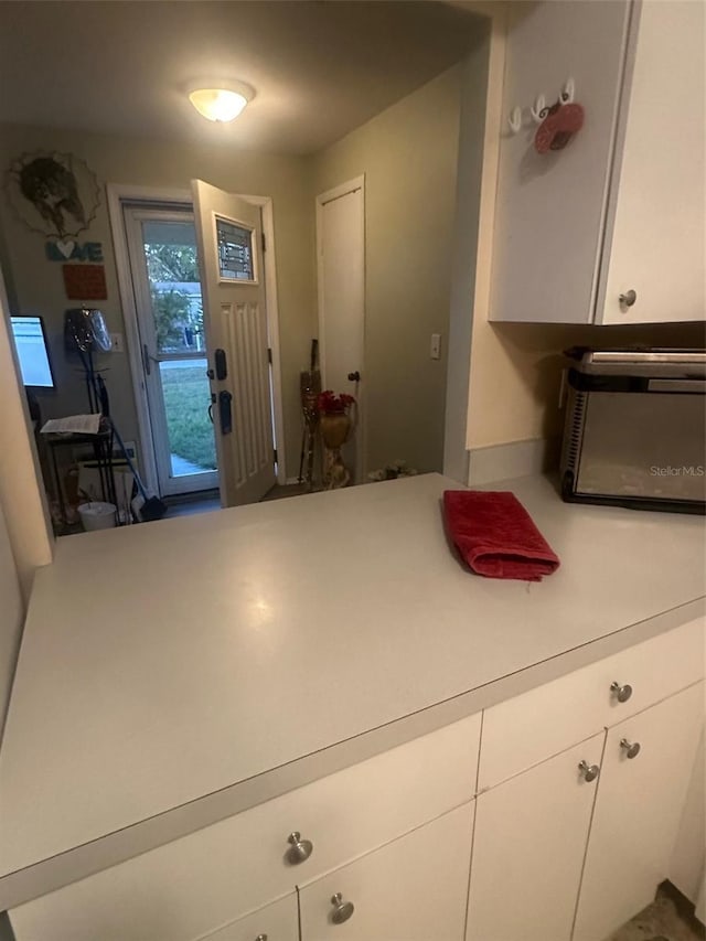 kitchen with white cabinetry and light countertops