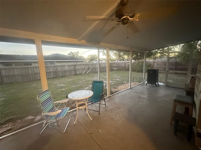 unfurnished sunroom with a ceiling fan