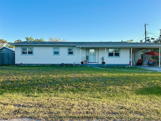 ranch-style house with an attached carport, a front lawn, and fence