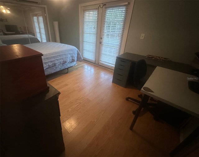 bedroom featuring access to outside and wood finished floors