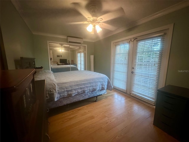 bedroom with access to exterior, a ceiling fan, ornamental molding, wood finished floors, and a wall mounted air conditioner