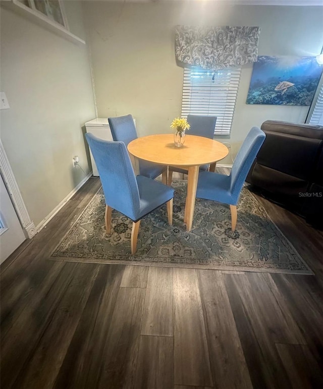 dining area featuring baseboards and wood finished floors