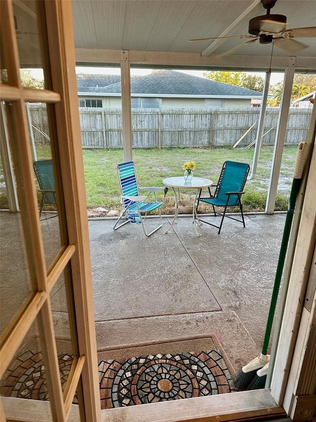 sunroom featuring a ceiling fan