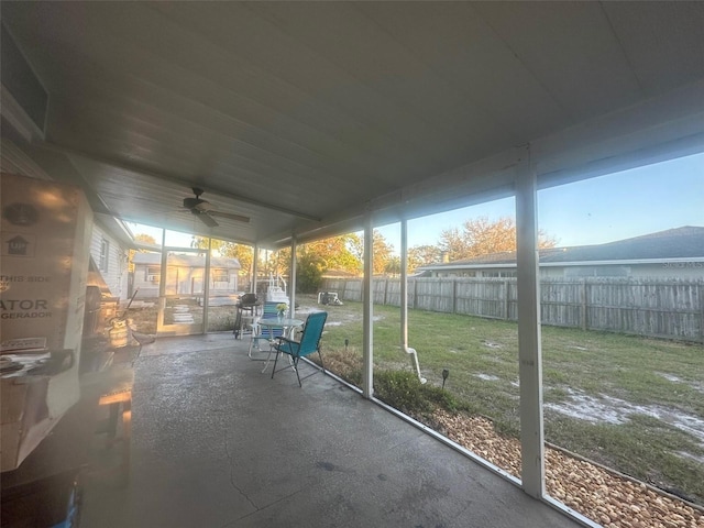 unfurnished sunroom with ceiling fan and a wealth of natural light