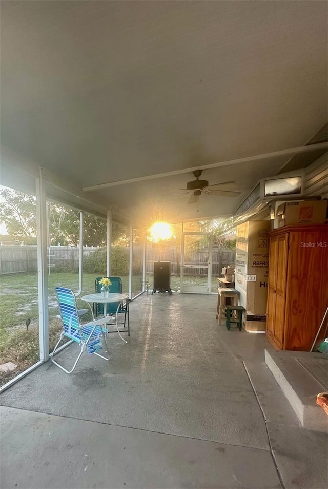 unfurnished sunroom featuring ceiling fan