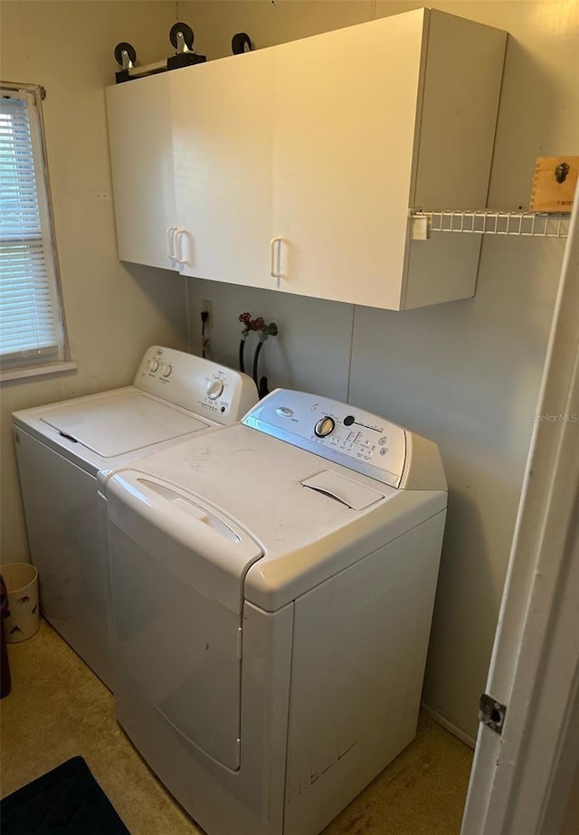 washroom featuring cabinet space and separate washer and dryer