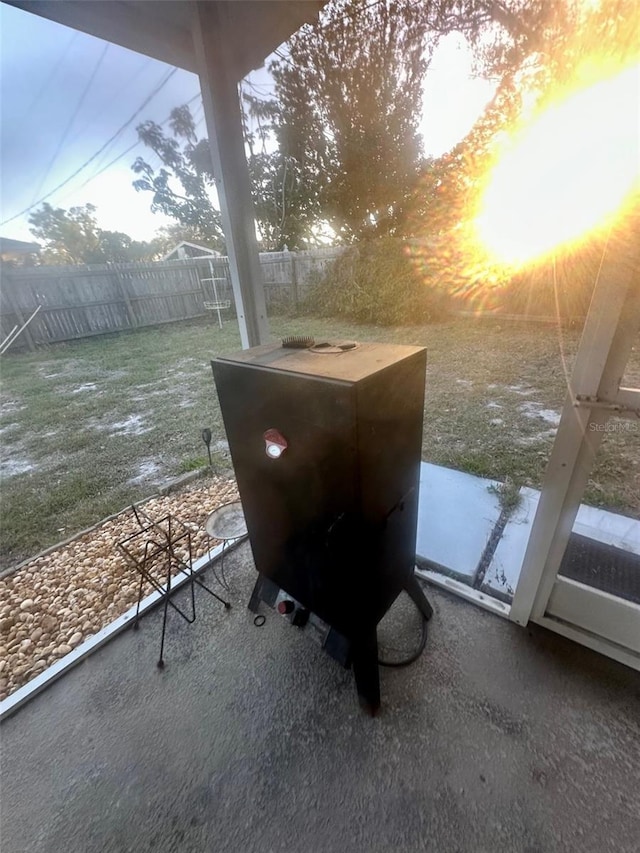 entry to storm shelter with fence private yard, a patio area, and a lawn