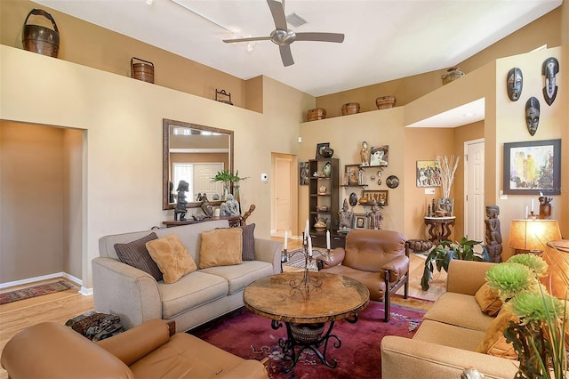 living room with visible vents, baseboards, ceiling fan, and wood finished floors