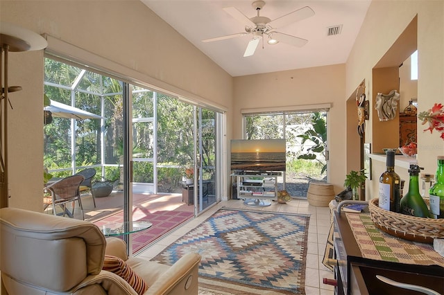 sunroom / solarium with visible vents, a ceiling fan, and lofted ceiling