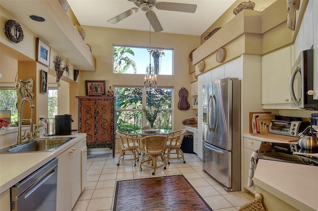 kitchen with a wealth of natural light, stainless steel appliances, light countertops, and a sink